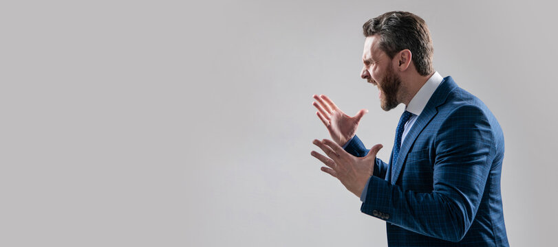 Distressful experience. Man face portrait, banner with copy space. Business man in suit, isolated studio background. Angry boss scream making wide gesture. Professional man scream in anger.