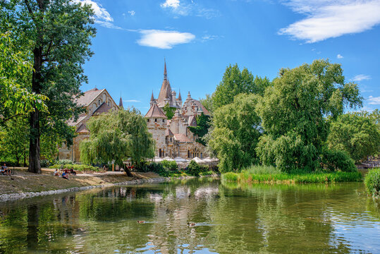 Historical building in Budapest - Vajdahunyad Castle with lake over the blue sky in main City Park.