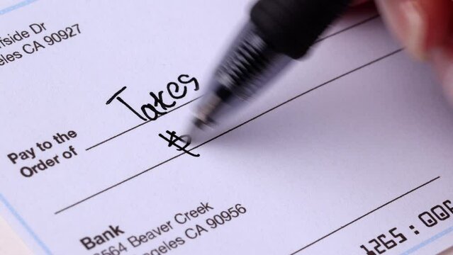 Close-up shot of a check being writen.
