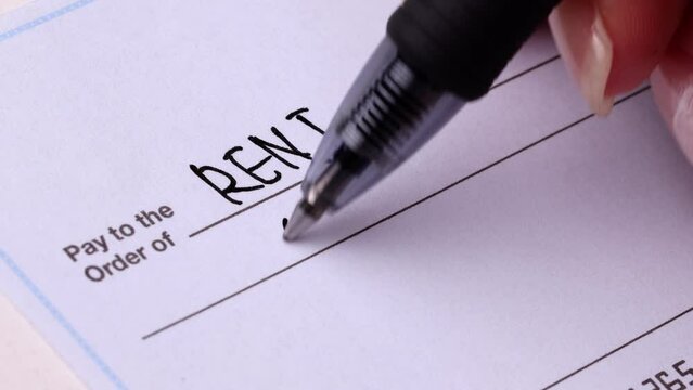 Close-up shot of a check being writen.
