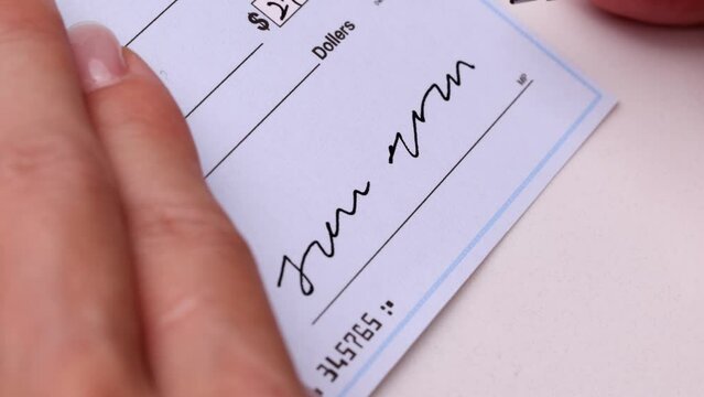 Close-up shot of a check being writen.