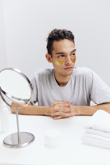 handsome guy golden patches on the face but sitting at the table isolated background