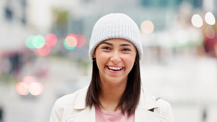 Happy young student laughing and smiling in a city on her way to work downtown. Trendy female intern laughing at a funny joke with a toothy smile traveling in town. A stylish girl in an urban area