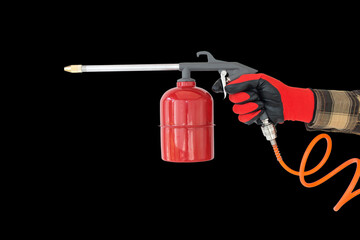 Naklejka premium flushing gun in the hand of a worker, on an isolated background