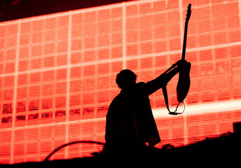 guitarist silhouette in stage lights