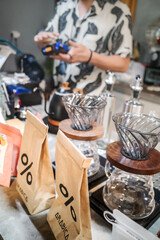 Coffee Making Equipment at Local Café with Seller on the Background