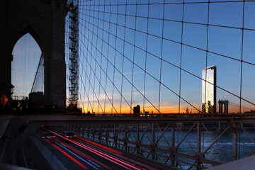 building at sunset from brooklyn bridge