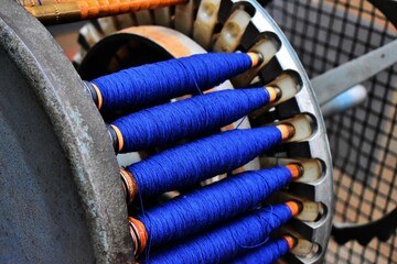 Closeup of a blue yarn rolls for a loom
