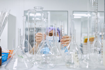 A girl scientist checks a sample for research
