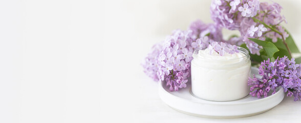 Concept of pure natural organic plant-based ingredients in cosmetology, herbal and flower extract. Lilac for anti-age and anti-acne therapy, gentle face and body skin care. Banner copy space