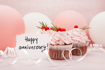 Happy anniversary - card with text and pink cup cakes, air balloons