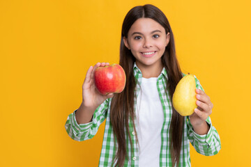 Fototapeta na wymiar positive kid with apple and pear on yellow background