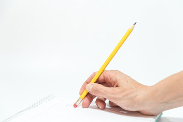hand erasing with the rubber of a pencil a sheet of a notebook
