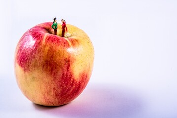 Two women on apple. Diorama.