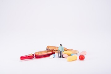 People with pills. Elder man. Diorama.