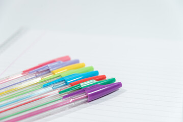 Obraz premium pens of different colors on a blank sheet