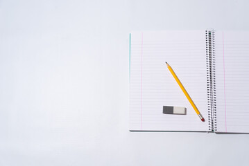 school equipment on blank notebook