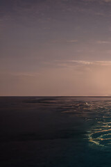 Resort holidays in the Maldives. Sunset in the Maldives. Boat on the water, palm tree. 3D illustration.