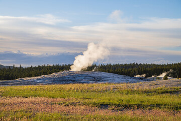 Sunset view of the Old Faithful geyser