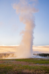 Sunset view of the Old Faithful geyser