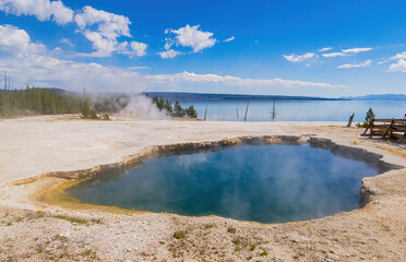 Sunny beautiful landscape of Abyss Pool in West Thumb of Yellowstone National Park
