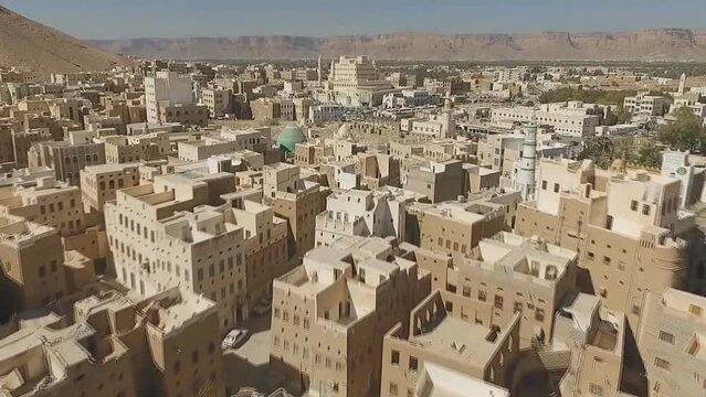 The ancient city of Hajrin in Hadhramaut, Yemen. It shows the valley of Doan, a mosque and houses made of mud.