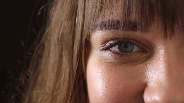 Raise your awareness to consciously shift your perspective to look for the positives in life. Closeup of a young woman with beautiful green eyes. Zoom in on a brunette woman feeling happy and content