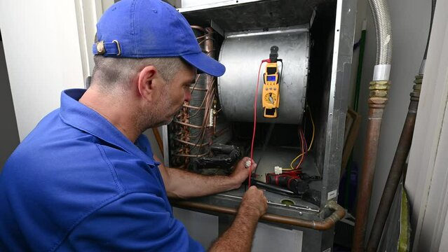 HVAC Technician Checking Voltage on a Wiring Harness