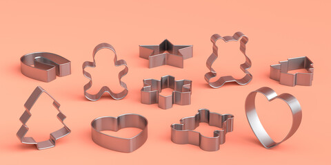 Set of metal cookie cutters for homemade Christmas biscuit on a coral background