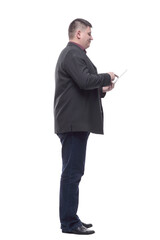 side view. Mature business man with a digital tablet.