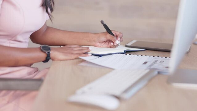 Female psychologist working on a schedule or online appointments and making notes in her calendar diary. One young professional therapist planning, checking and filing information on desktop computer