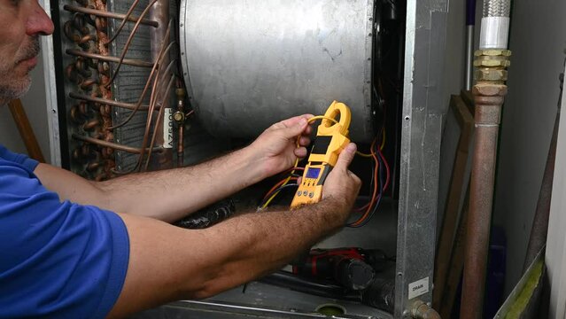 HVAC Technician Checking Current on Motor Wire