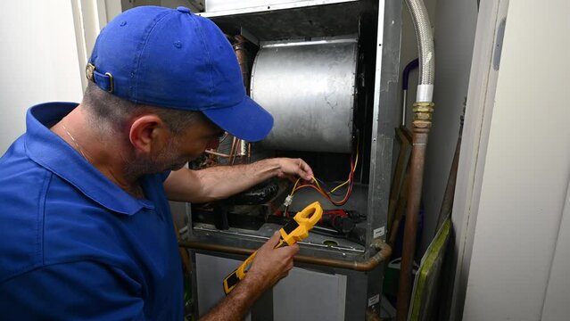 HVAC Technician Checking Current on Motor