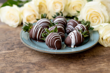 Chocolate covered strawberries and flowers white roses
