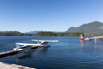 Fototapeta premium Dock and Seaplanes in the Harbour on a Sunny Afternoon on Vancouver Island. Summer Season. Tofino, British Columbia, Canada. Adventure Travel.