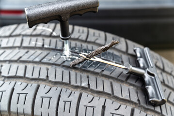 Tubeless tire repair, close-up. Tire plug repair kit for tubeless tires for cars and motobikes