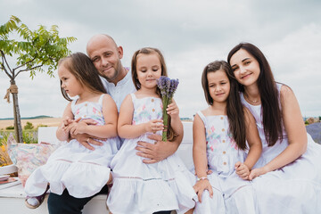 Dad and mom happy family kissing hugging.Concept of family playing in the park.