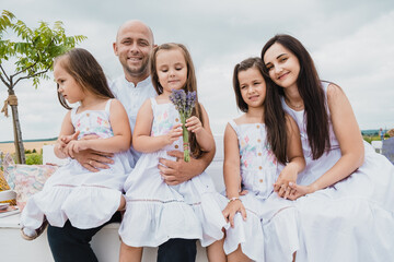 happy family children kid together playing in the park.Happy kids dad and mom are kissing and hugging.