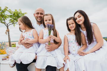 Dad and mom happy family kissing hugging.Concept of family playing in the park.