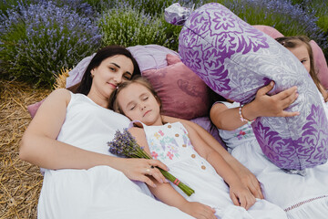  Cute beautiful children.Family vacation.Two sisters sincerely smile.Cheerful family lying on the...