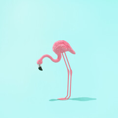 Minimal summer or caribbean concept. .Trendy sunlight Summer composicion made with pink flamingo toy on bright light blue background. Creative art minimal aesthetic.