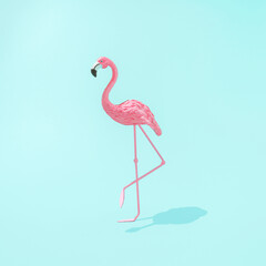Minimal summer or caribbean concept. .Trendy sunlight Summer composicion made with pink flamingo toy on bright light blue background. Creative art minimal aesthetic.