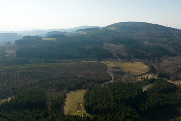 Fototapeta na wymiar Aerial view of pine forest with large area of cut down trees as result of global deforestation industry. Harmful human influence on world ecology