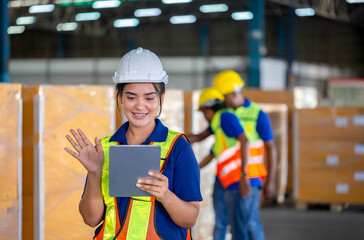 Female worker during video chat conference taking inventory in factory warehouse, Warehouse workers team working in logistics center, Manual workers working in warehouse talking about job