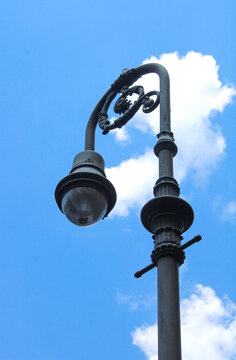 Vintage street lamp against soft blue sky