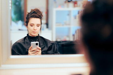 Funny Woman Talking a Selfie in the Mirror in a Hair Salon. Client thinking and regretting haircut decision 

