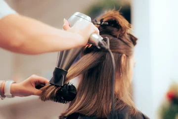  Woman Having her Hair Straighten with a Brush and a Hair Dryer. Hairdresser drying clients hair working with professional tools  © nicoletaionescu