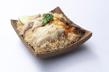 Side view of Hainanese chicken glutinous rice mix with Fried Chicken. Served in a coconut-patterned dish. On white floor or isolated white background.