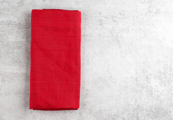 Red cotton napkin on marble background, copy space