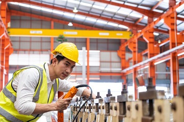 Selective focus at Asian men engineer supervisor, wearing safety equipment. While doing audit for...